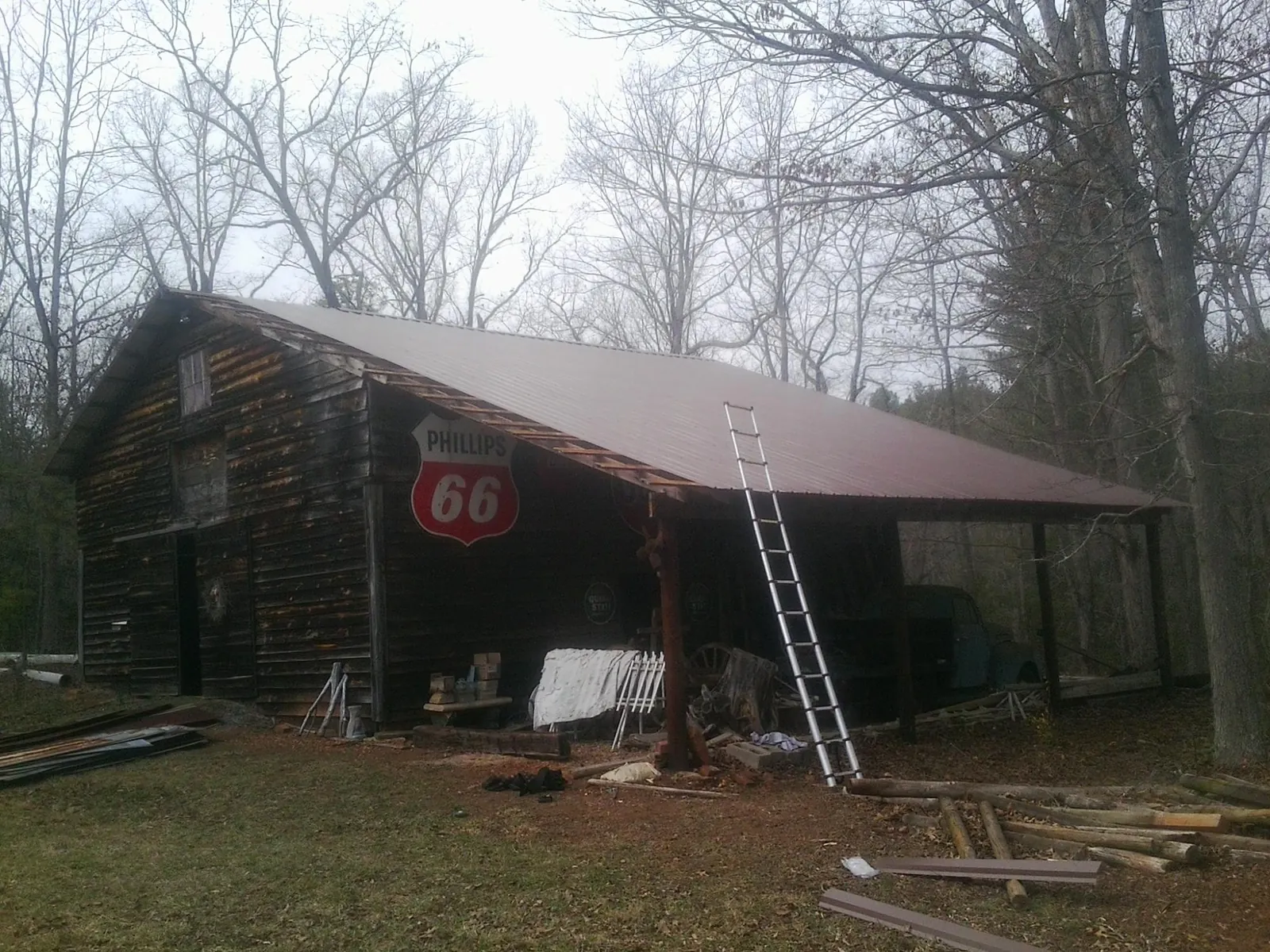 New metal roof on an open sided timber barn with a vintage sign in Burr Hill